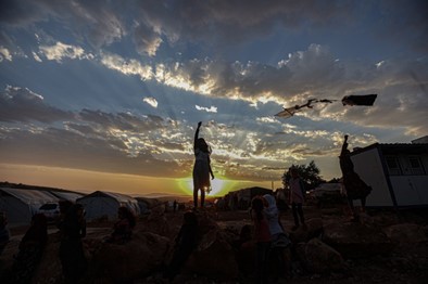 A group of people standing on top of a hill.