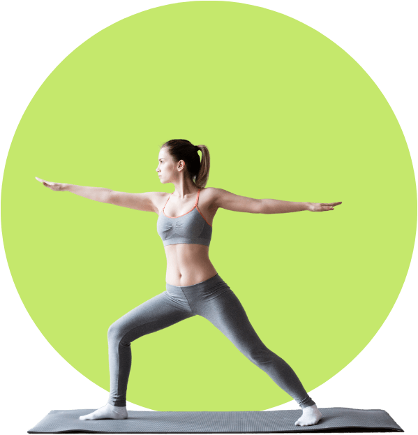 A woman in grey outfit doing yoga on green background.