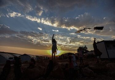 A group of people standing on top of a hill.